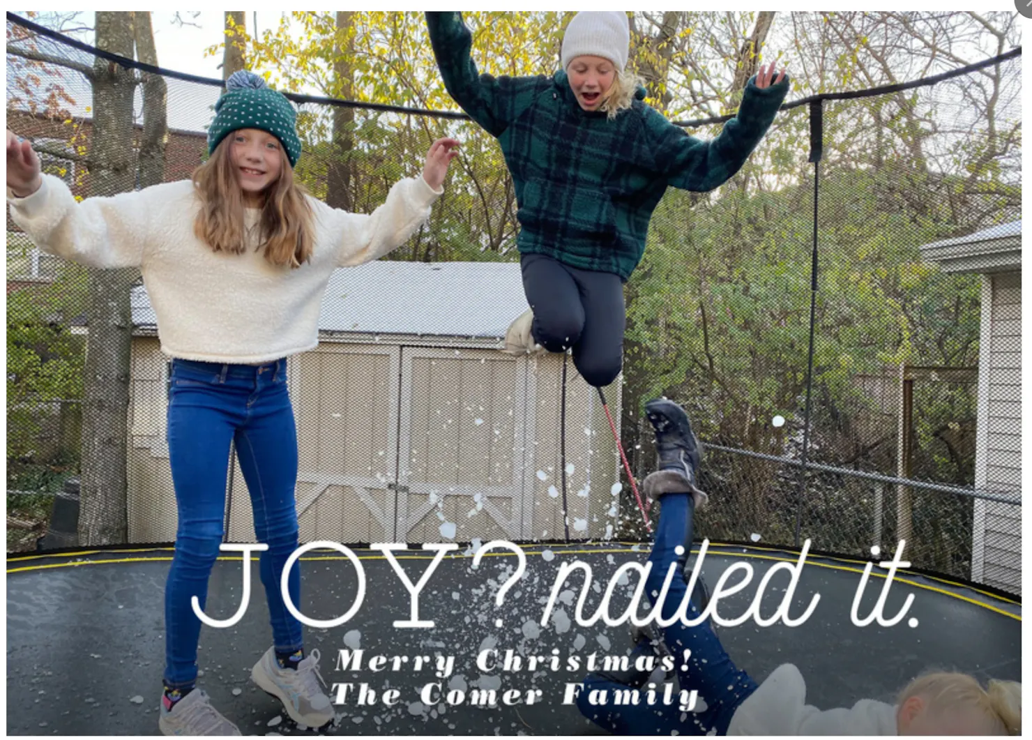 The Comer family's 2020 Christmas card: kids leaping on a trampoline in fake snow with the words 'Joy? Nailed it. Merry Christmas! The Comer Family'