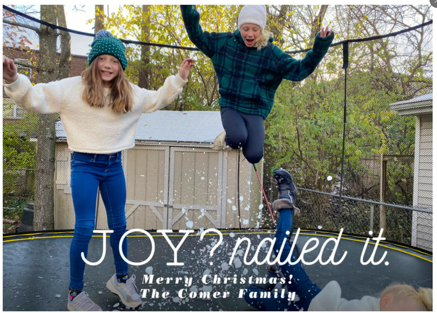 The Comer family's 2020 Christmas card: kids leaping on a trampoline in fake snow with the words 'Joy? Nailed it. Merry Christmas! The Comer Family'