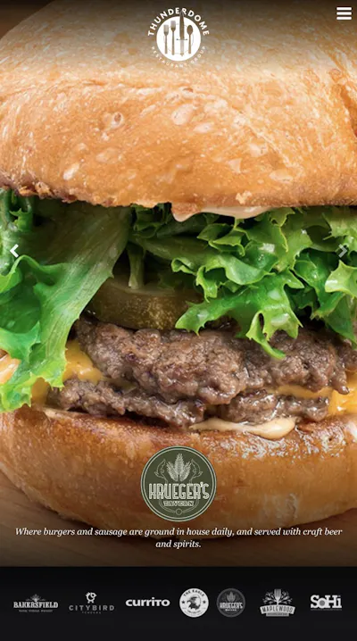 Mobile screenshot of the Thunderdome Restaurant Group site featuring a Krueger's Tavern burger and restaurant logos