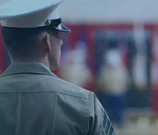 Marine in dress uniform seen from behind at a ceremony, for the RecruitMilitary project