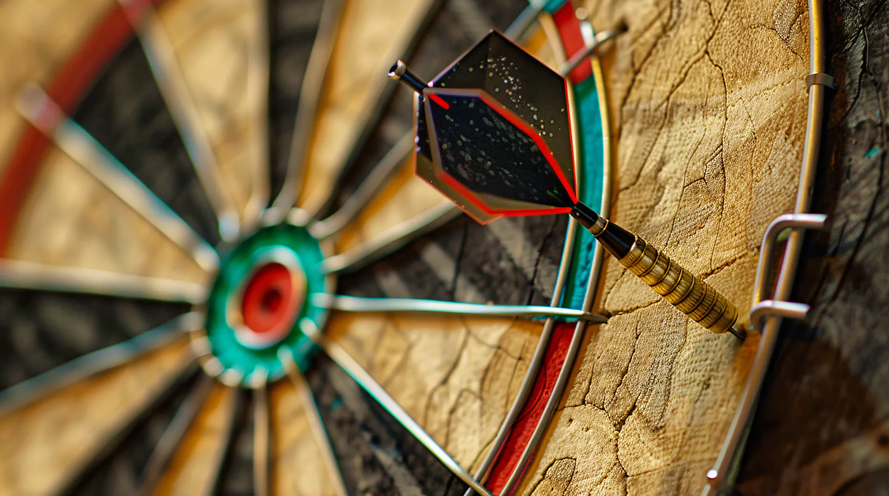 Close-up of a dart stuck in the outer ring of a dartboard, well off the bullseye